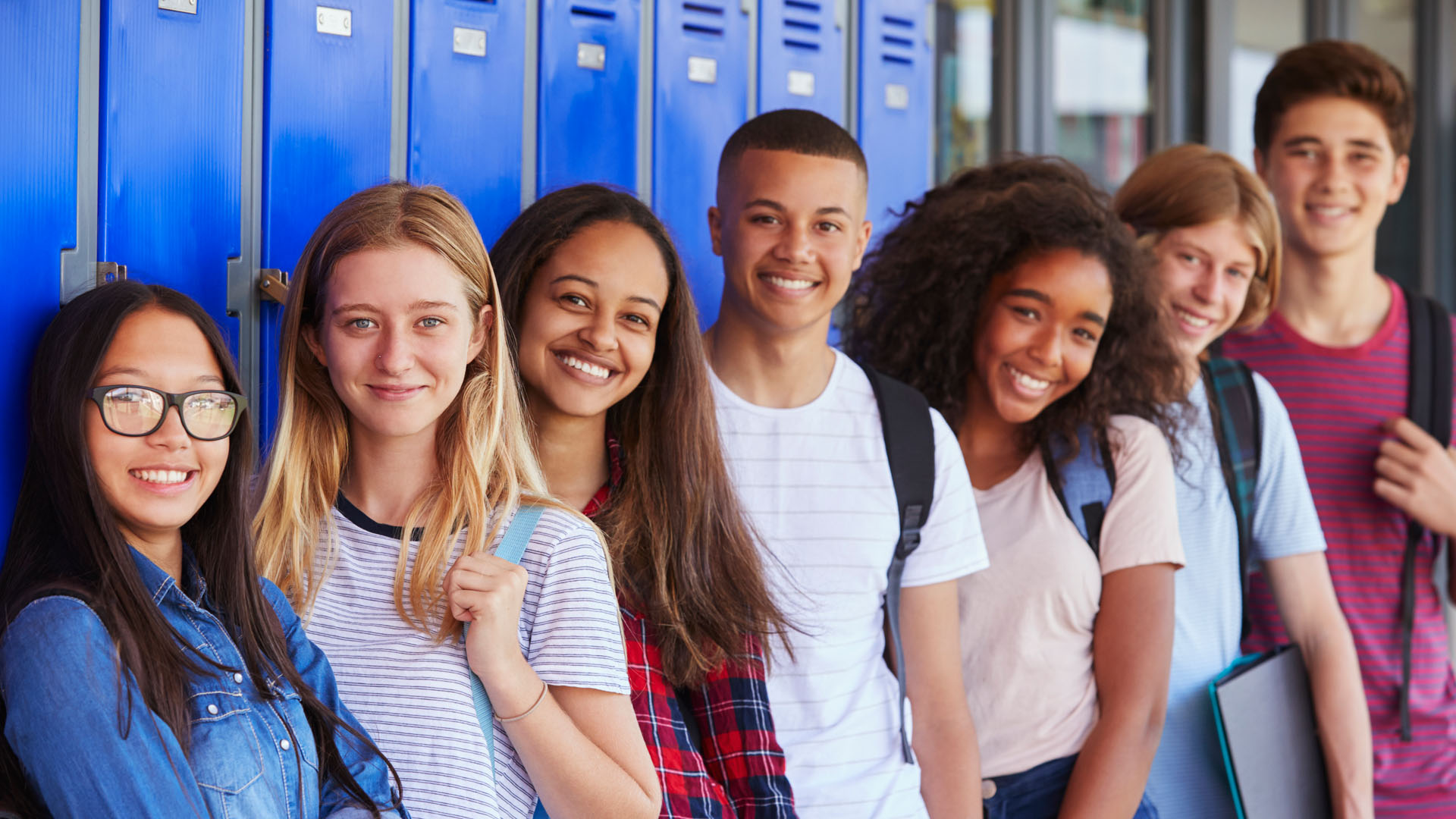 Group of youth standing in front of lockers