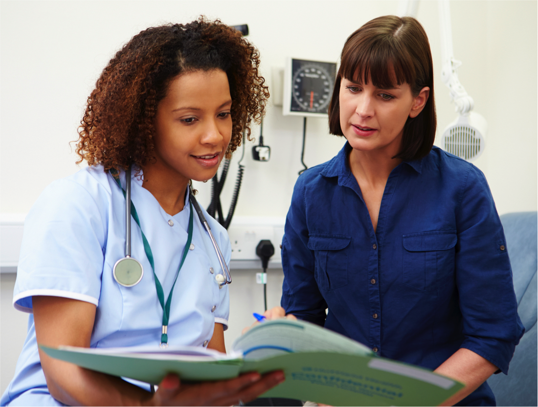 Female nurse talking to female patient