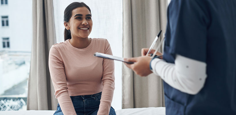 Nurse discussing alcohol consumption with patient.